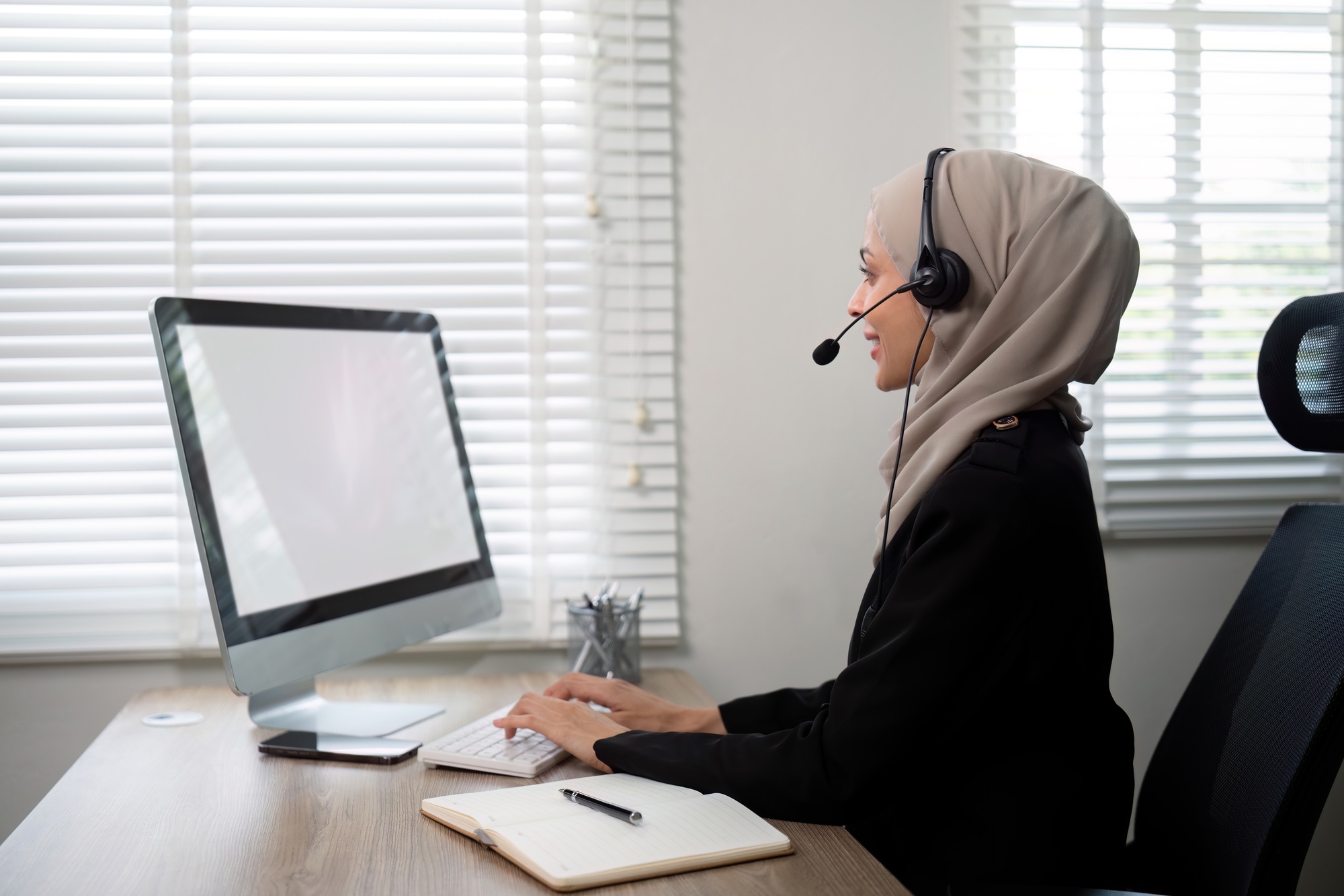 Young muslim women wearing hijab telemarketing or call center agent with headset working on support