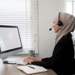 Young muslim women wearing hijab telemarketing or call center agent with headset working on support
